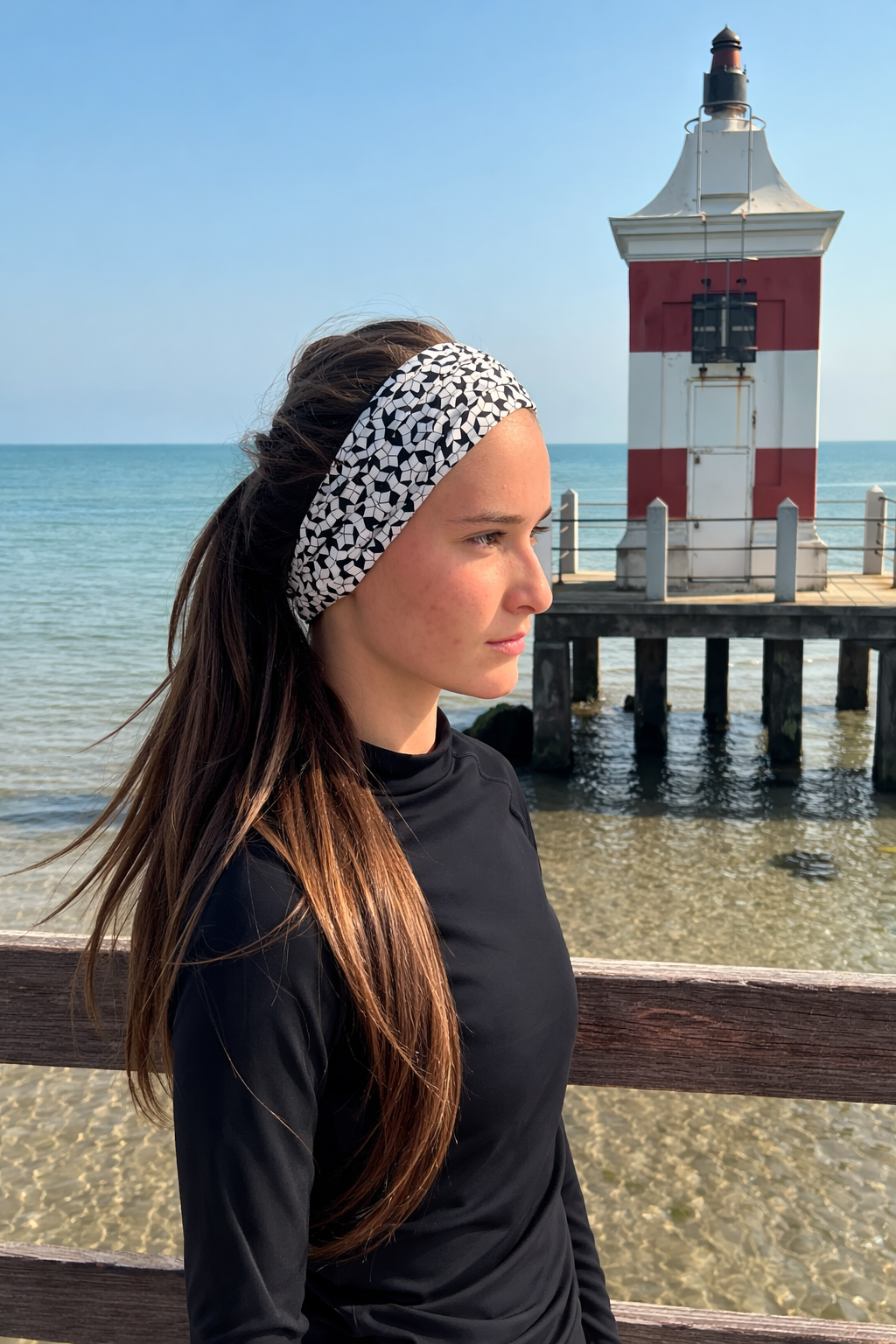 Girl wearing Level 1001 neckwear near lighthouse