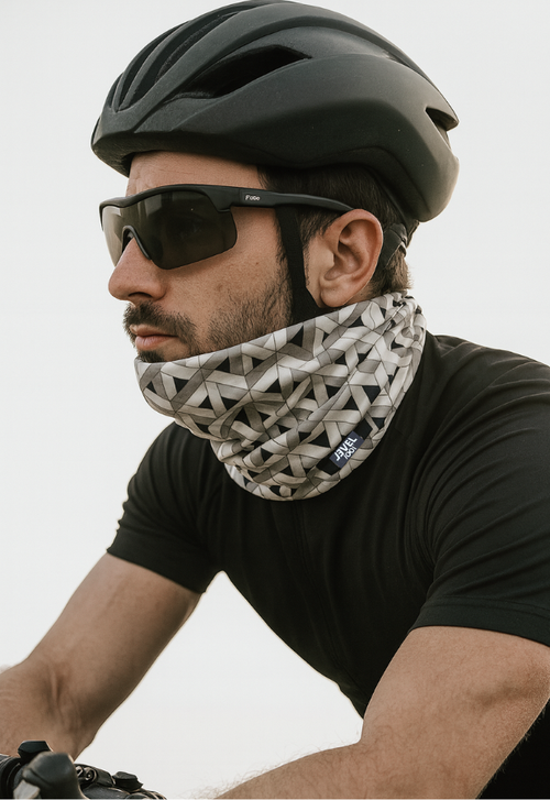 Young man on a bike wearing a Level 1001 neckwear, connection model