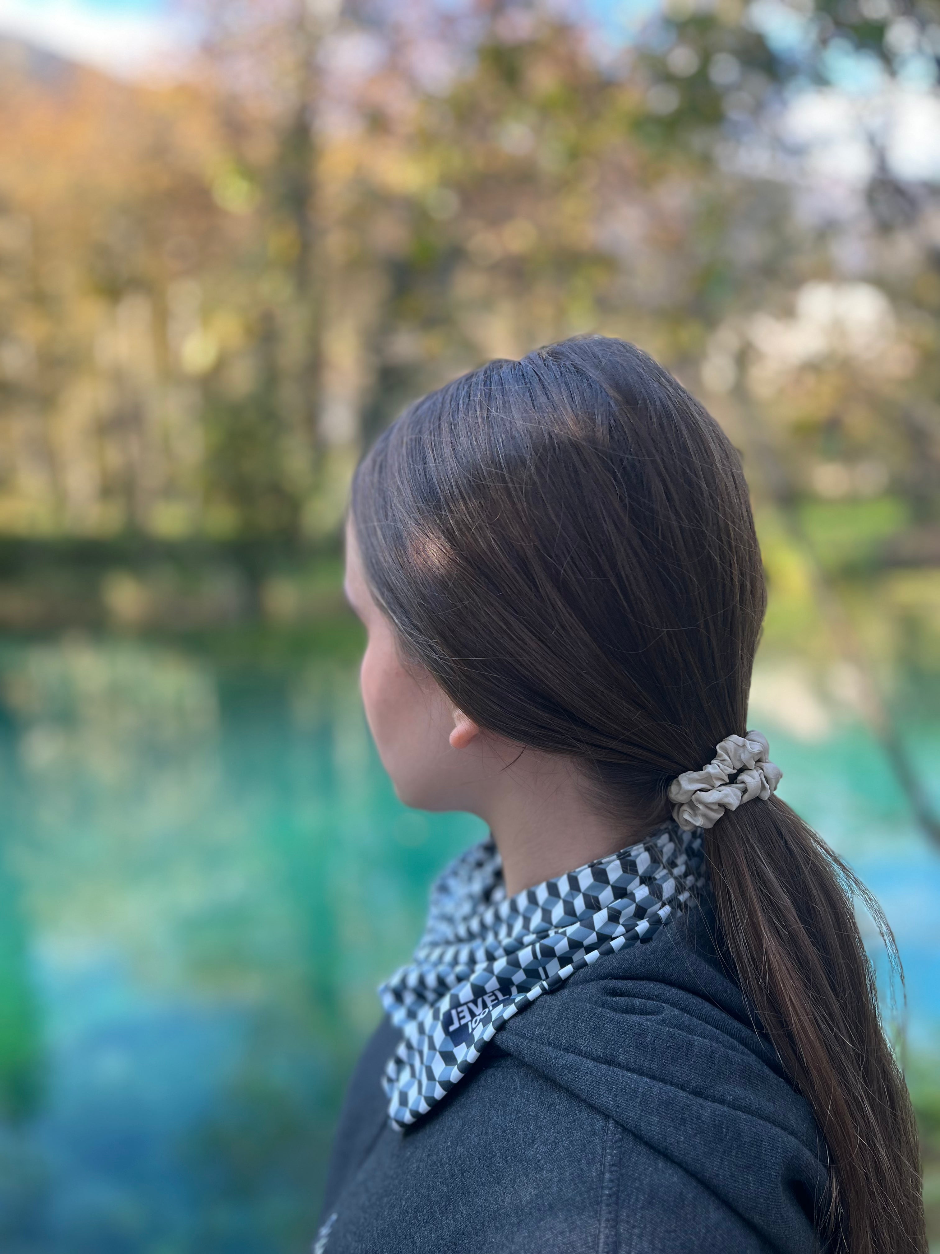 girl wearing a neckwear near the lake